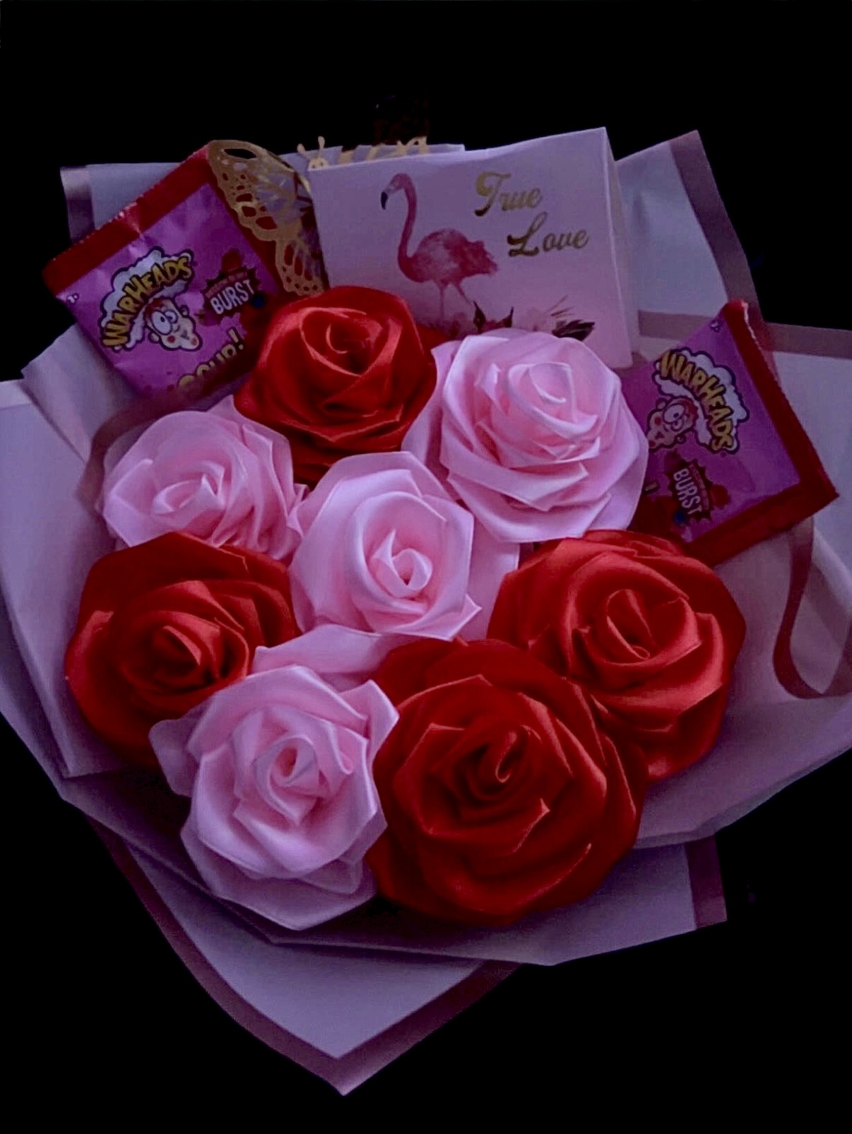 Red and pink satin rose bouquet with candy, a butterfly and a True Love card